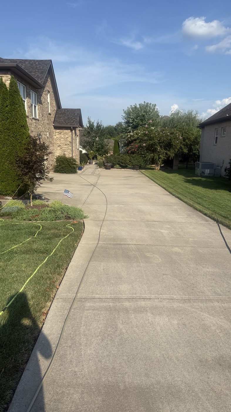 Driveway before pressure washing, dull and stained