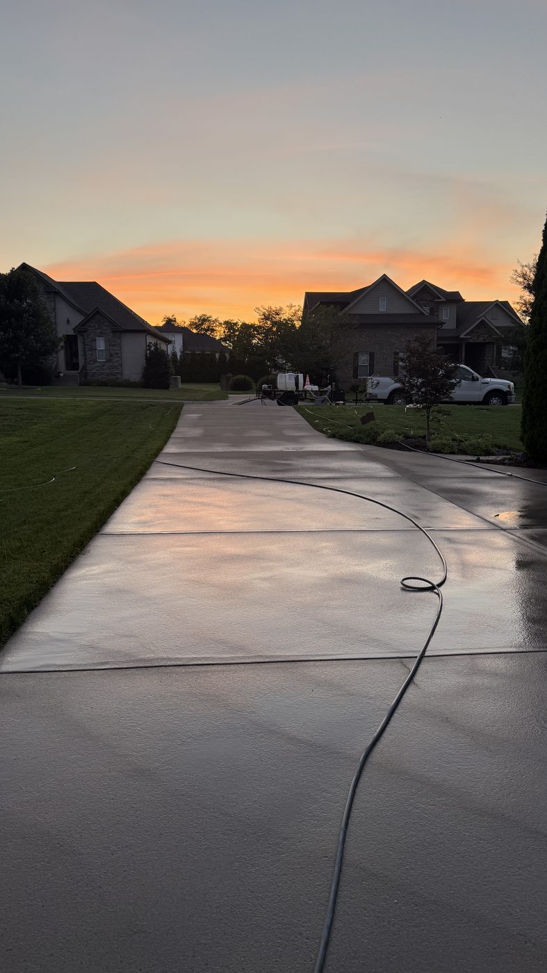 Clean driveway reflecting the sunset after washing
