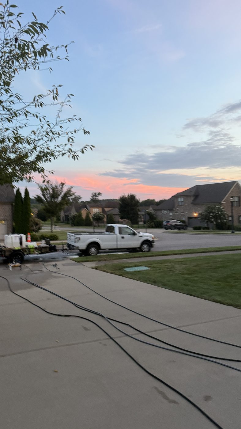 Halo rig set up on the street at dusk, hoses run up the driveway